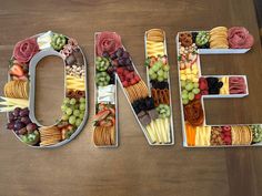 the word one is made up of fruits, vegetables and crackers in the shape of letters