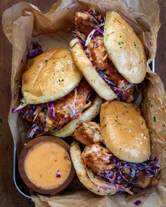 chicken sliders with coleslaw and mustard in a basket