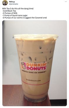 a dunkin donuts drink sitting on top of a table