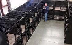 a man is standing in front of several cages