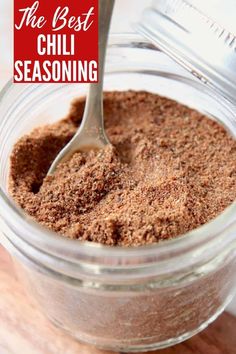 the best chili seasoning in a glass jar with a spoon inside it and text overlay that reads, the best chili seasoning