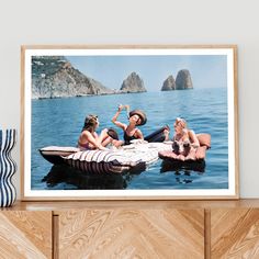 there are three women sitting on a raft in the water