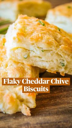 flaky cheddar chive biscuits on a cutting board with text overlay