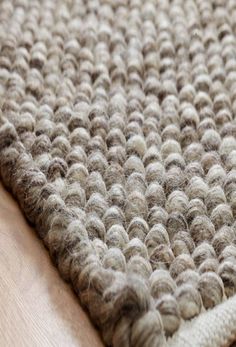 a close up view of a rug on a wooden floor with no one around it