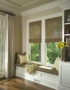 a window seat in the corner of a living room with sunflowers on it