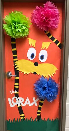 the lorax door is decorated with tissue pom poms and paper flowers