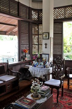 a living room filled with furniture and lots of windows