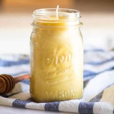 a jar filled with honey sitting on top of a towel