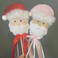 two santa and mrs claus lollipops on sticks