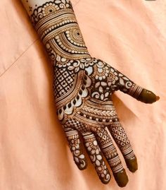 a henna on someone's hand with intricate designs