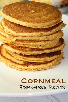 stack of cornmeal pancakes on a white plate with the words cornmeal pancakes recipe