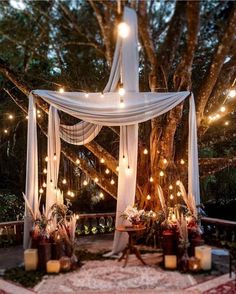 a gazebo decorated with candles and lights