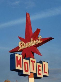 a stardust motel sign with a red and white star on it's top