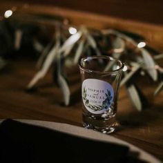 a shot glass sitting on top of a wooden table