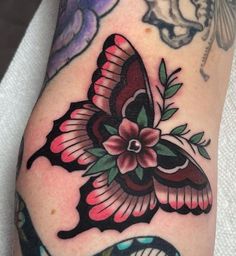 a close up of a person's leg with tattoos on it and a butterfly