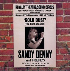 a poster on the side of a brick wall advertising sandy denny and friends at royal theatre in london