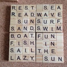 four scrabble tiles with words on them sitting on the floor next to a toothbrush