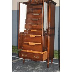 an old wooden armoire with many drawers