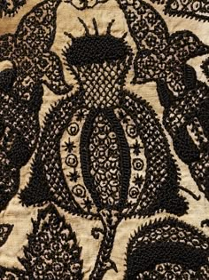 an intricate black and white pattern on fabric