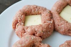 four cookies with cheese are on a white plate