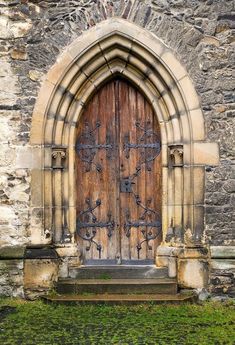 an old stone church with a wooden door