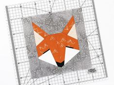 a close up of a piece of paper with a fox on it's face