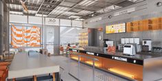 an orange and white checkout counter in a large room with lots of chairs around it