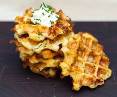 a stack of waffles with sour cream on top