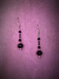 Elevate your gothic Victorian style with these stunning black facetted bead and silver dangle earrings. The intricate design of these earrings captures the essence of a bygone era, combining the dark elegance of gothic fashion with the intricate details of Victorian style. Perfect for adding a touch of drama to any outfit, these earrings are sure to make a statement wherever you go. Handcrafted with care and attention to detail, these earrings are a unique and stylish addition to your jewelry co Black Faceted Beads Dangle Jewelry, Black Dangle Jewelry With Faceted Beads, Black Faceted Bead Earrings For Gift, Black Faceted Beads Earrings For Party, Black Faceted Beads Earrings For Gift, Black Beaded Sterling Silver Earrings, Black Faceted Bead Drop Earrings, Black Faceted Beaded Drop Earrings, Elegant Black Beaded Earrings With Faceted Beads