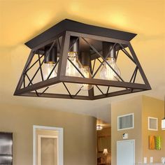 a light fixture hanging from the ceiling in a kitchen