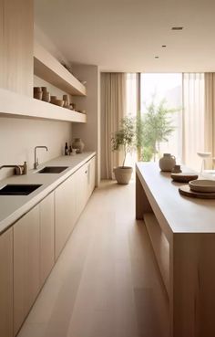 a kitchen with white countertops and wooden cabinets next to a large sliding glass door