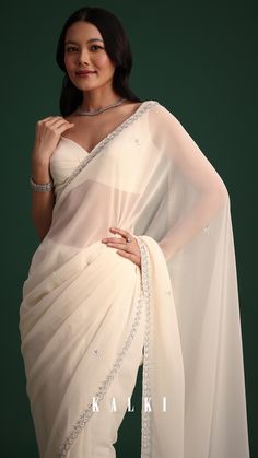 This white georgette saree radiates grace with its detailed cutdana embroidery.
The lightweight fabric drapes effortlessly creating a look that’s both timeless and stylish suitable for both formal gatherings and festive occasions. Draped Fabric, Georgette Sarees, Saree, Festival, Fabric, White