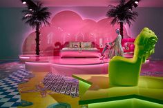 a living room filled with furniture and palm trees in the middle of pink hues