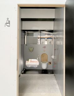 a bathroom with a toilet, sink and other items in the stall that is open