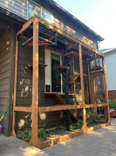 a house with a large chicken cage on the front porch