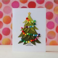 a christmas tree card with pom - poms on the bottom and an ornament at the top