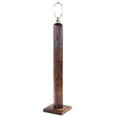 a tall wooden pole with a light on it's end and a chain hanging from the top