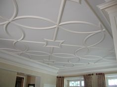 the ceiling is painted white and has decorative designs on it