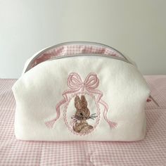 Finished Bunny and Bow Embroidered Makeup Bag Size: 20x10x9cm ✂️%100 cotton fabric. 🧼Washing Instructions: It can be hand washed. Please don't iron. 📦 Packaging: The products are shipped out within 1-2 working days. Makeup Bags For School, Cute Skincare Bags, Pink Makeup Pouch, Sewed Makeup Bags, Pretty Makeup Bag, Customized Makeup Bag, Embroidered Cosmetic Bag, Cute Cosmetic Bag, Embroidery Makeup Bag