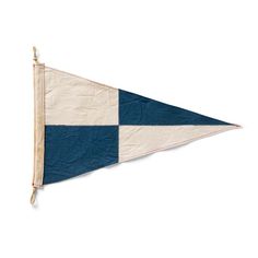 an old blue and white flag hanging on a wall with a wooden stick sticking out of it