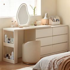 a bedroom with a dresser, mirror and other items on the table in front of it