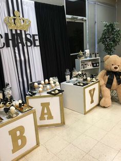 a teddy bear sitting next to some baby shower items