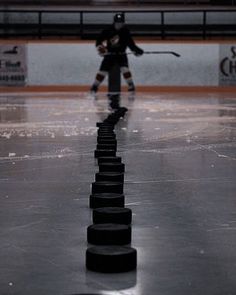 an ice hockey player is skating on the rink with his stick and puck in hand