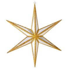 a gold and white star ornament hanging from a string