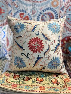 a decorative pillow sitting on top of a chair