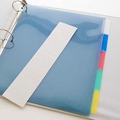 a binder and pen sitting on top of a blue folder