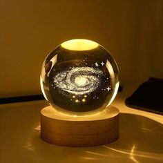 a glass ball sitting on top of a wooden stand