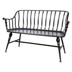 an old metal bench with black paint and wood slats on the back, against a white background