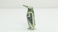 an origami bird made out of one dollar bill