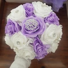 a bridal bouquet with purple and white flowers